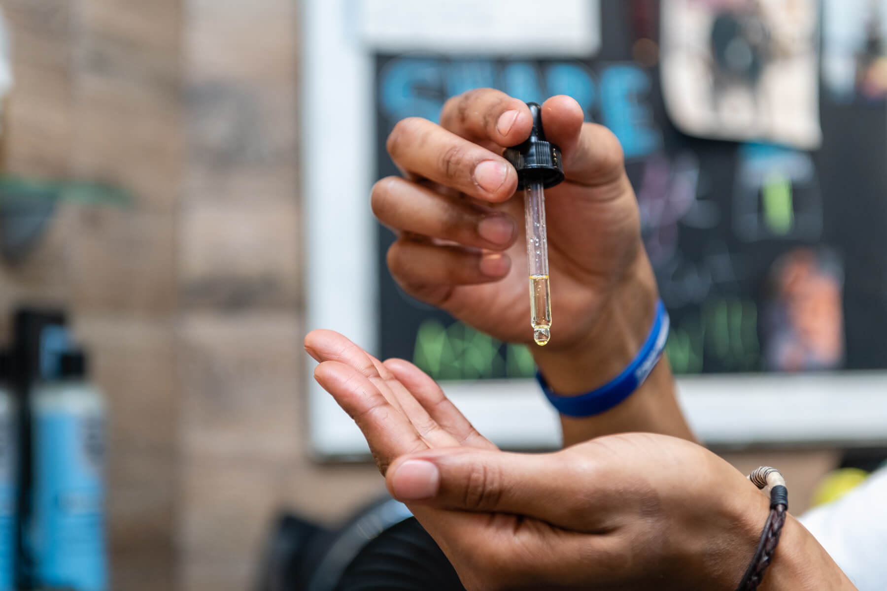 A woman holds a dropper and dropper with a drop of moisturizing serum for face and body skin care. Skin care concept