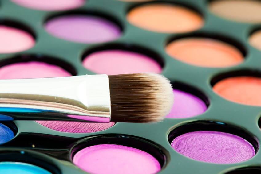 Multicolored eye shadows with cosmetics brush